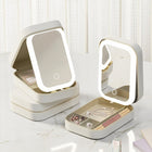 Two cream-colored portable jewelry organizers with integrated LED lighted mirrors.