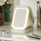 White portable LED makeup mirror with lighting on a marble vanity