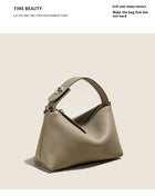 Tan pebbled leather handbag with a structured top handle and silver hardware.
