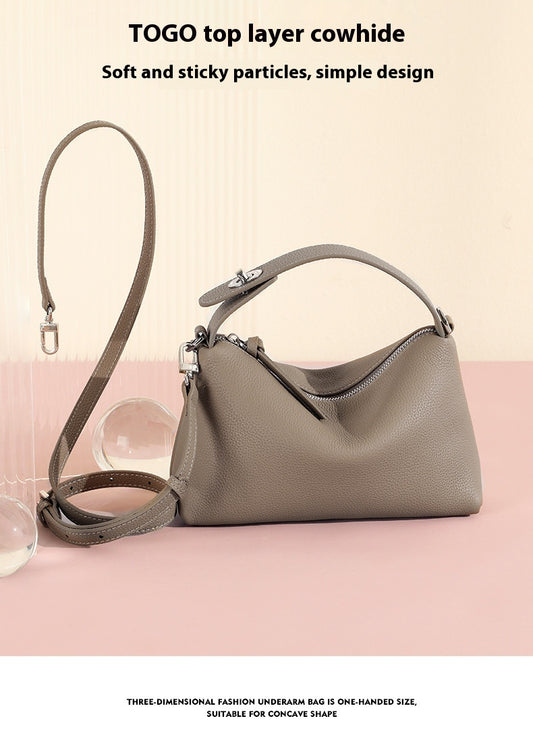 Taupe Togo leather underarm bag with a top handle and adjustable shoulder strap.