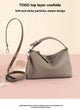 Taupe Togo leather underarm bag with a top handle and adjustable shoulder strap.