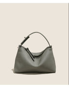Grey pebbled leather handbag with a single shoulder strap and zipper closure.