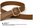 Close-up of a brown faux leather bag shoulder strap with an adjustable gold-tone buckle