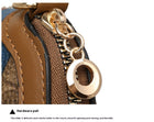 Close-up of a gold-tone hardware zipper pull on a brown textured leather bag.