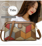 Woman wearing a geometric pattern faux leather crossbody shoulder bag with earthy tones.