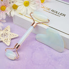 White jade roller and gua sha set with rose gold accents and flowers