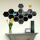 Hexagonal black mirror wall decor arranged in a honeycomb pattern above a console table.