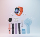 Collection of lifestyle tech accessories including a smartwatch with orange band, earbuds, and a mini fan.