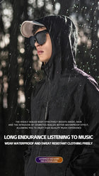 Man in black waterproof hooded jacket and sunglasses listening to music in the rain.
