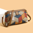 Multi-color patchwork leather crossbody bag with geometric pattern and tan shoulder strap