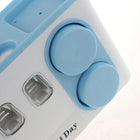 Blue and white daily pill organizer with circular compartments for weekly medication storage.