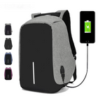 Grey and black USB charging backpack with smartphone charging cable connection.