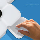 Close-up of a hand using a white storage container with an anti-pinch design.