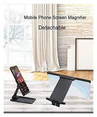 Detachable mobile phone screen magnifier stand for enhanced viewing.