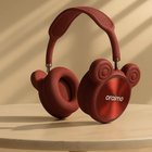 Red oraimo wireless headphones with cute bear ear design on a marble surface.