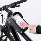 A black bicycle handlebar bag holding a smartphone, mounted on a black bike frame.