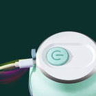 Mint green portable electronic device being charged via white USB cable.