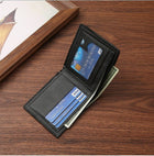 Black leather bifold wallet containing credit cards and cash on a wooden surface.