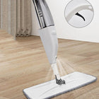 Electric cordless spin mop cleaning a wooden floor with a close-up of the power button.