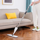 Person using a spray mop to clean a hardwood floor in a modern living room