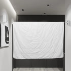 White quilted comforter hanging as a room divider in a modern minimalist interior