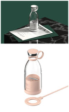 Portable glass blender bottle with pink silicone sleeve and straw for fresh juice.
