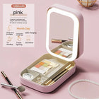 Pink portable makeup organizer case with built-in LED mirror and makeup storage
